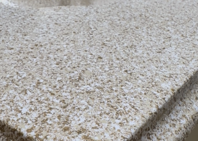 Image of our Sienna Stone fish for countertops. You can see light gold, and cream colored pattern on a bathroom vanity top.