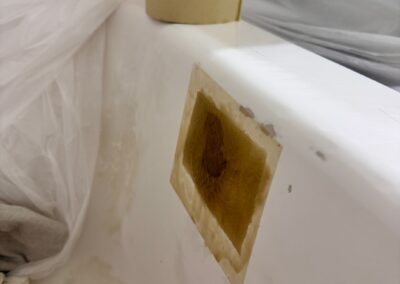 Chipped bathtub area prepared for repair during bathtub resurfacing